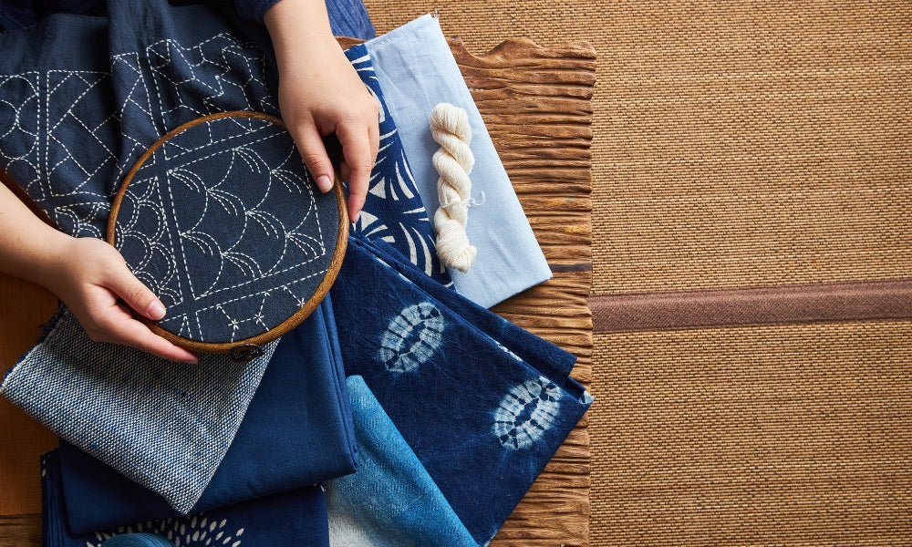 Traditionelle japanische Sashiko-Stickerei auf Indigostoff mit weißem Garn in geometrischen Mustern